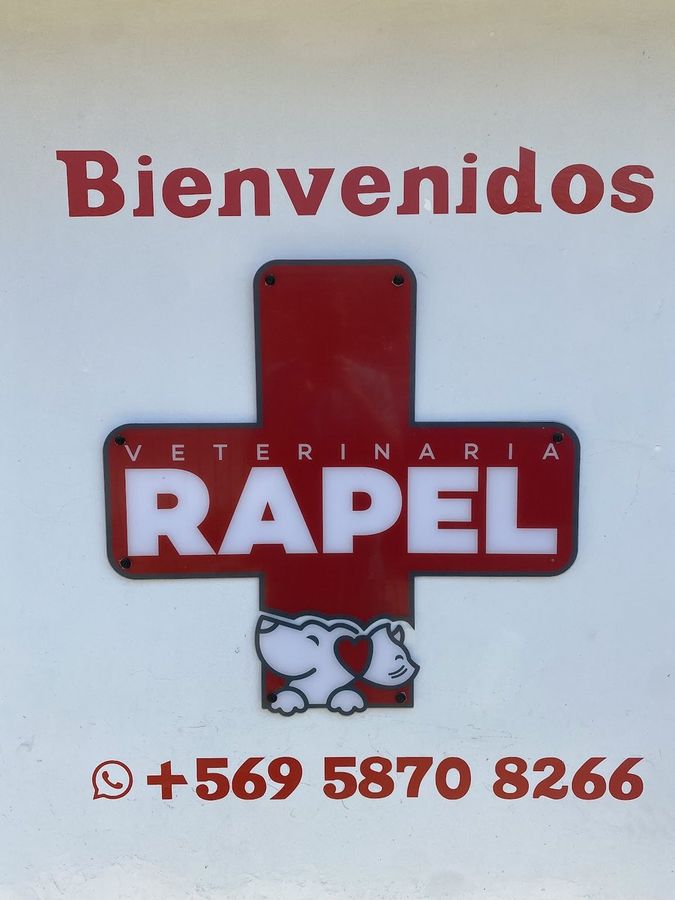 Letrero de metal en la fachada: Bienvenidos, cruz de Veterinaria Rapel y WhatsApp +56 9 5870 8266.